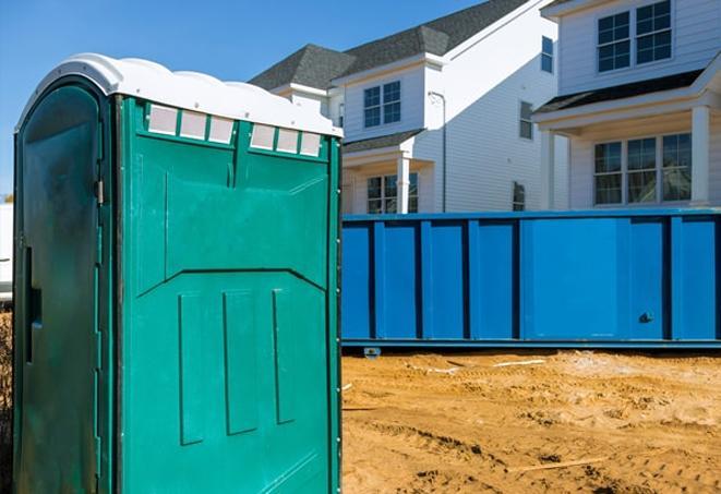 a row of porta potties at a job site